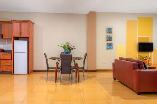a living room with a table and a couch at Bukoto Heights Apartments in Kampala