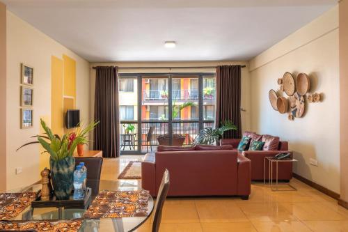 a living room with a couch and a table at Bukoto Heights Apartments in Kampala
