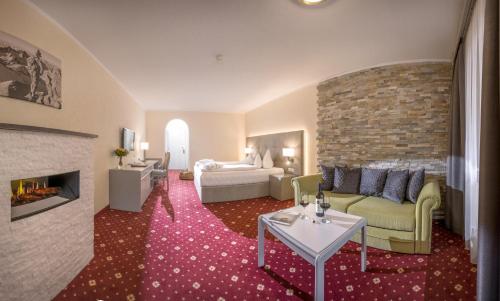 a living room with a couch and a fireplace at Garni Das SONNALP in Maurach
