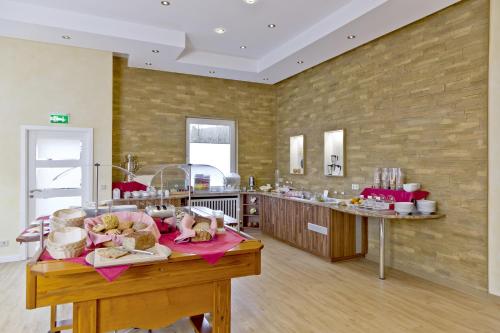 a kitchen with a table with food on it at Hotel Bavaria Oldenburg in Oldenburg