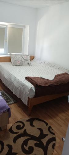 a bedroom with a bed in a room with a rug at Casa Vio in Eforie Nord