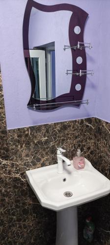 a bathroom with a sink and a mirror at Casa Vio in Eforie Nord