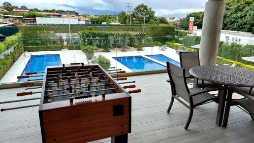 a chess board on a deck with a table and chairs at Altamira Cozy apartment with amazing views in Santo Domingo