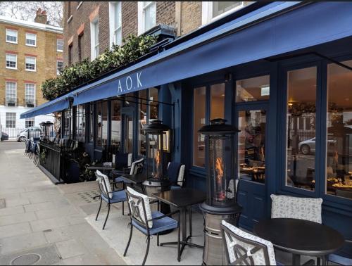 a restaurant with tables and chairs in front of a building at Stunning 1 Bedroom in Stunning Location - Mayfair Area in London