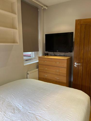 a bedroom with a bed and a flat screen tv at Stunning apartment in the heart of Central London in London