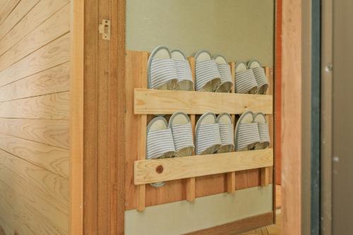 a cabinet filled with plates and bowls on shelves at 南箱根ツリーハウス in Kannami