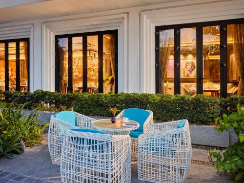 a table and chairs sitting in front of a building at Ravatel Luxury Hotel Bac Giang in Bắc Giang