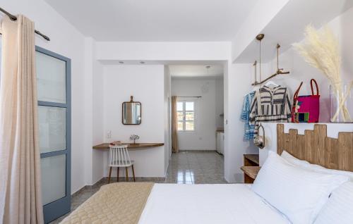 a bedroom with a white bed and a table at eLea in Adamas
