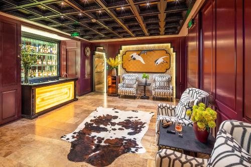 a living room with two chairs and a table at Ravatel Luxury Hotel Bac Giang in Bắc Giang