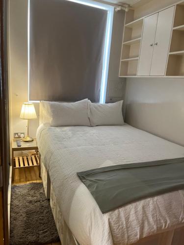 a bedroom with a large bed with a window at Stunning apartment in the heart of Central London in London