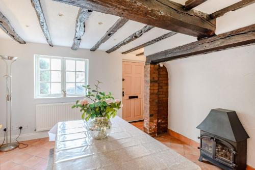 a living room with a table and a fireplace at Darwen in Rugeley