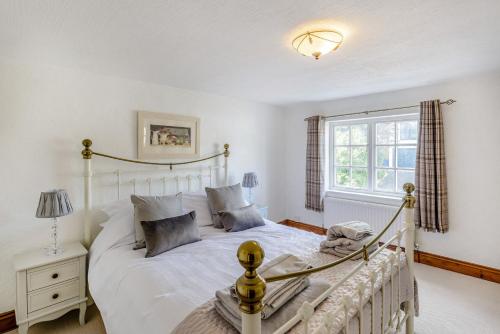 a bedroom with a white bed and a window at Darwen in Rugeley
