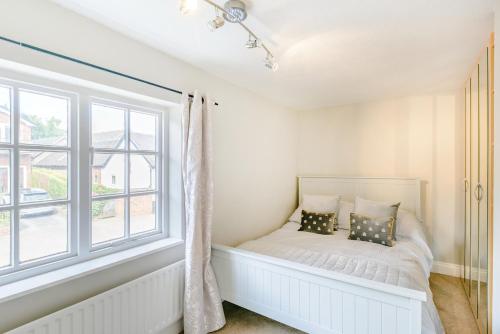 a bed in a room with a window at Darwen in Rugeley