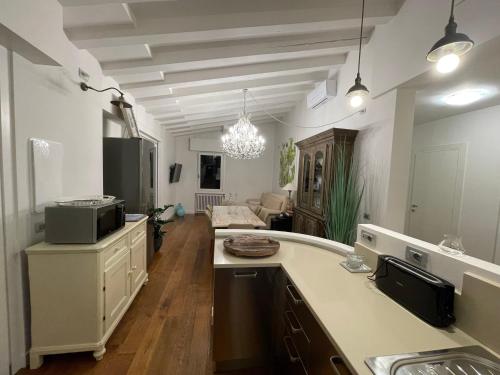 a kitchen with a counter and a living room at Villa Elvira in Gardone Riviera