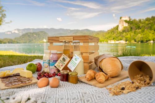 a picnic with bread and other foods on a blanket at Vila Gorenka in Bled