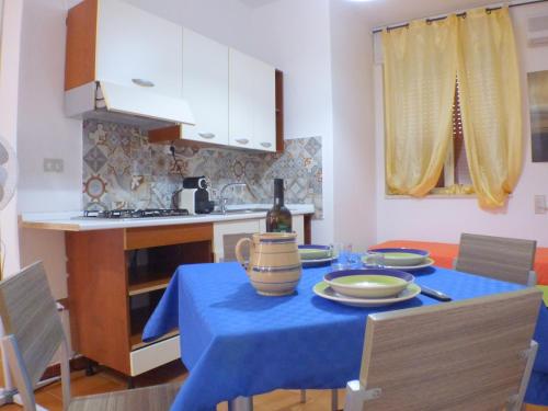 a kitchen with a table with a blue table cloth on it at Casa Vacanze Donn'Anna in Porto Cesareo