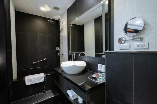a bathroom with a sink and a mirror at XINSHE Hotel - Linsen in Taipei