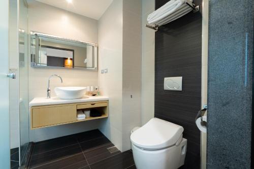 a bathroom with a white toilet and a sink at XINSHE Hotel - Linsen in Taipei