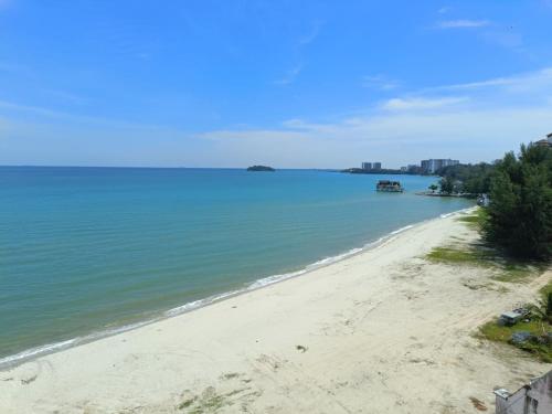 a view of a beach with a boat in the water at PD Paradise Lagoon North Penthouse B-2-4 in Kampong Baharu