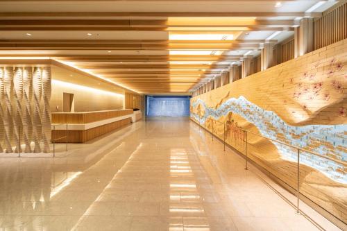 a hallway of a building with a large mural on the wall at ALA HOTEL KYOTO in Kyoto