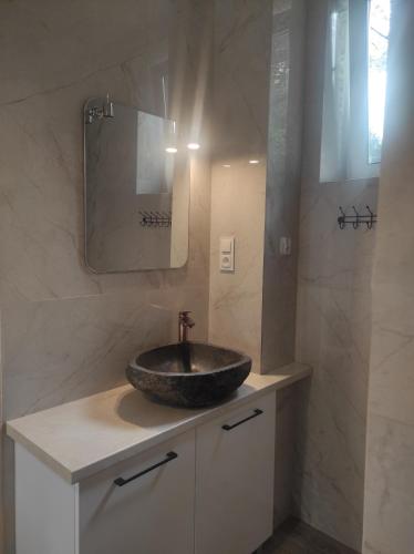 a bathroom with a sink and a mirror at Dom Wakacyjny Krawno in Piecki