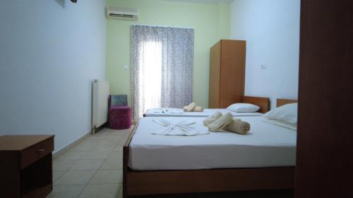a bedroom with two beds with towels on them at Villa Minas in Paralia Katerinis