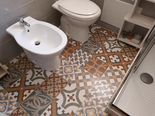 a bathroom with a toilet and a sink at A casa del Nonno in Isnello