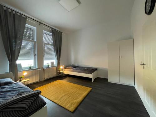 a bedroom with a bed and a large window at Herne Zentral Apartment in Herne