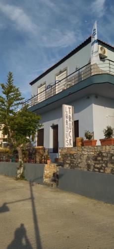 a building with a sign on the side of it at Ilio Socrates in Skala Marion