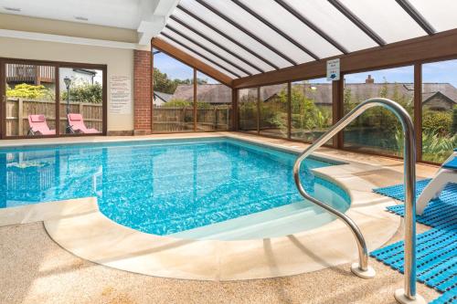 a swimming pool in a house with at Croft Farm & Celtic Cottages in Cardigan