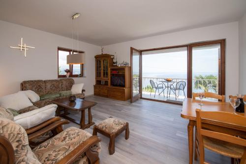 a living room with a couch and a table at Bela Vista 5 Rustikales Appartement in Volosko