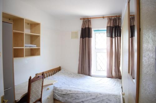 1 dormitorio con cama y ventana en Near Sea House Stay, en Bangor