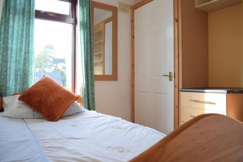 a bedroom with a bed with a window and a window at House Stay in Bangor North Wales in Bangor