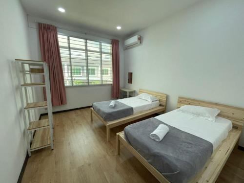 Кровать или кровати в номере Wawasan Sweet Home - UTS Sibu