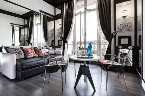 a living room with a couch and a table at Point-Of-View Champs Elysees in Paris
