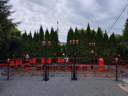 a playground with a red train in front of trees at Penzion Restaurace u Helferů in Libuň