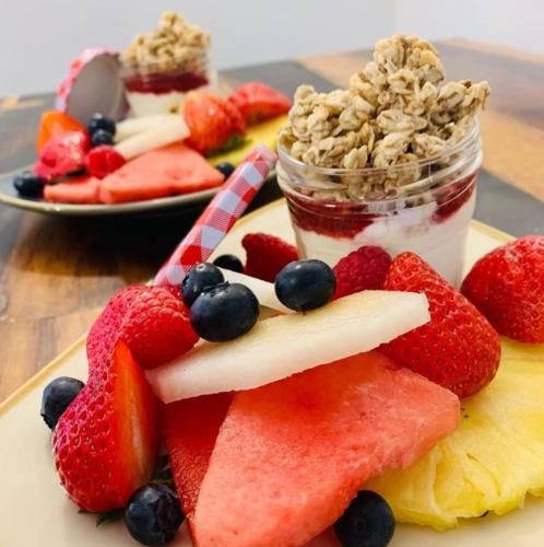 a plate with fruit and a jar of granola and yogurt at Florence House Boutique Hotel and Restaurant in Portsmouth