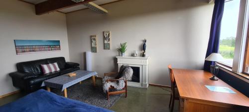 a living room with a couch and a table at Solheim Guesthouse in Dverberg