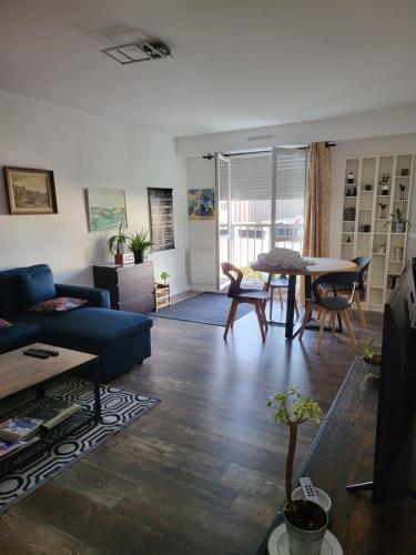 un salon avec un canapé bleu et une table dans l'établissement 09Launay Bouhier 09, à Nantes