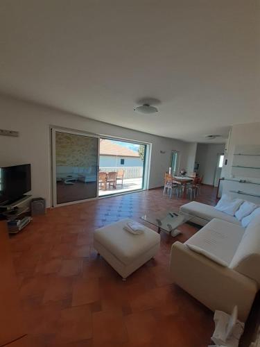 a large living room with a couch and a table at Apartments Iličić in Supetar