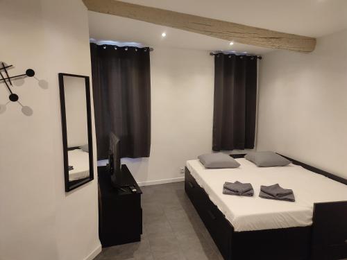 a bedroom with a bed and a mirror and a television at Coup de coeur in Ceyreste