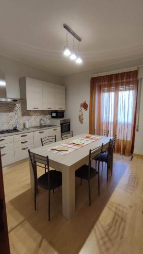 a kitchen with a table and chairs in a room at R Family in Acireale