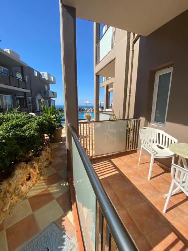 a balcony with a view of the ocean at Girogiali beach hotel - Adults only in Stalos