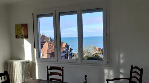 a window in a room with a table and chairs at Auberge du Vieux Puits in Dieppe