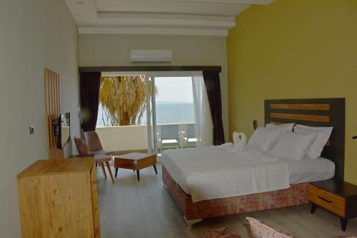 a bedroom with a bed and a view of the ocean at Villa Sevilla in Kusadası