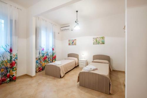 Posteľ alebo postele v izbe v ubytovaní Villa Due Palme by Villa Plus