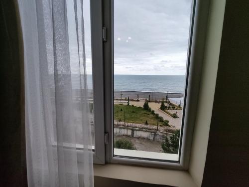 a window with a view of the beach at Guesthouse White Swan in K'obulet'i