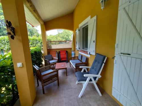 - une terrasse couverte avec un bouquet de chaises dans l'établissement Gîte à BELESTA en Ariège 09300, à Bélesta