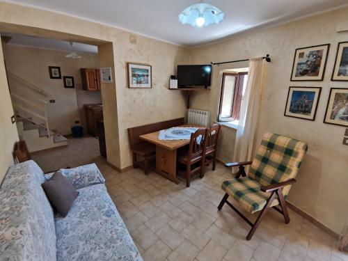 a living room with a couch and a table at Il Torrione in Poggio Bustone