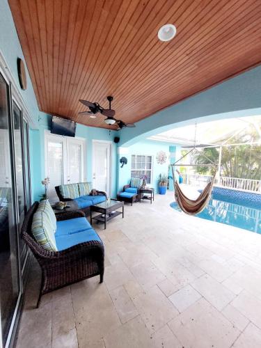 a living room with a couch and a hammock at Cape Paradise B & B - Your Luxury Tropical Retreat in Cape Coral